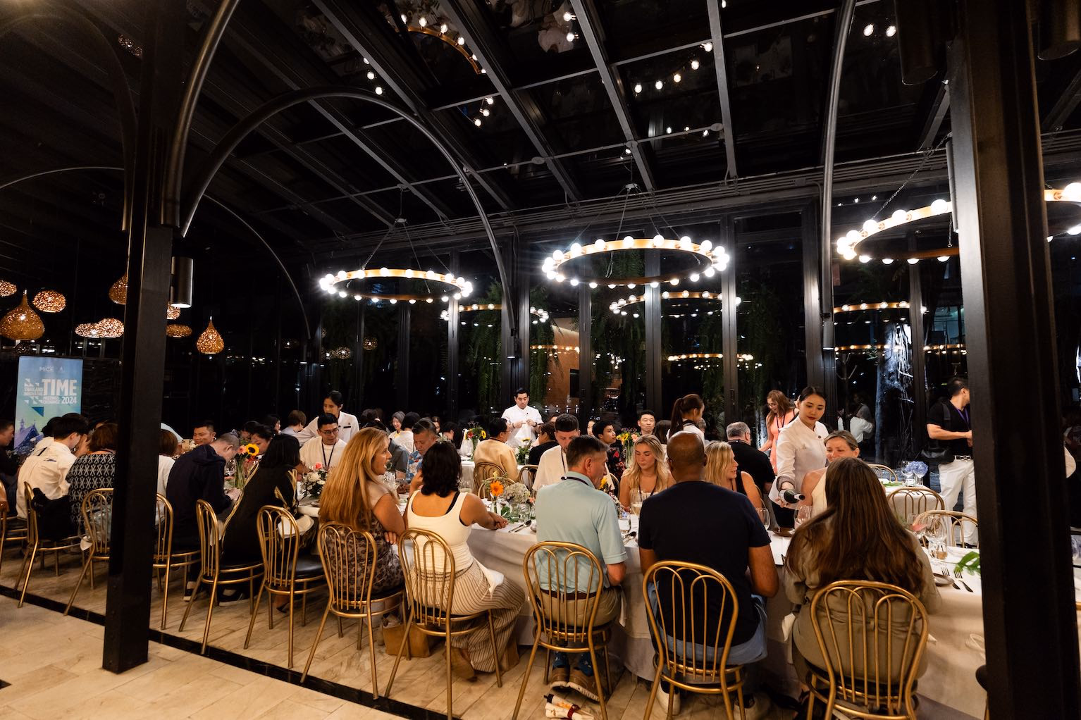 Guests gathering for an evening reception inside a contemporary venue