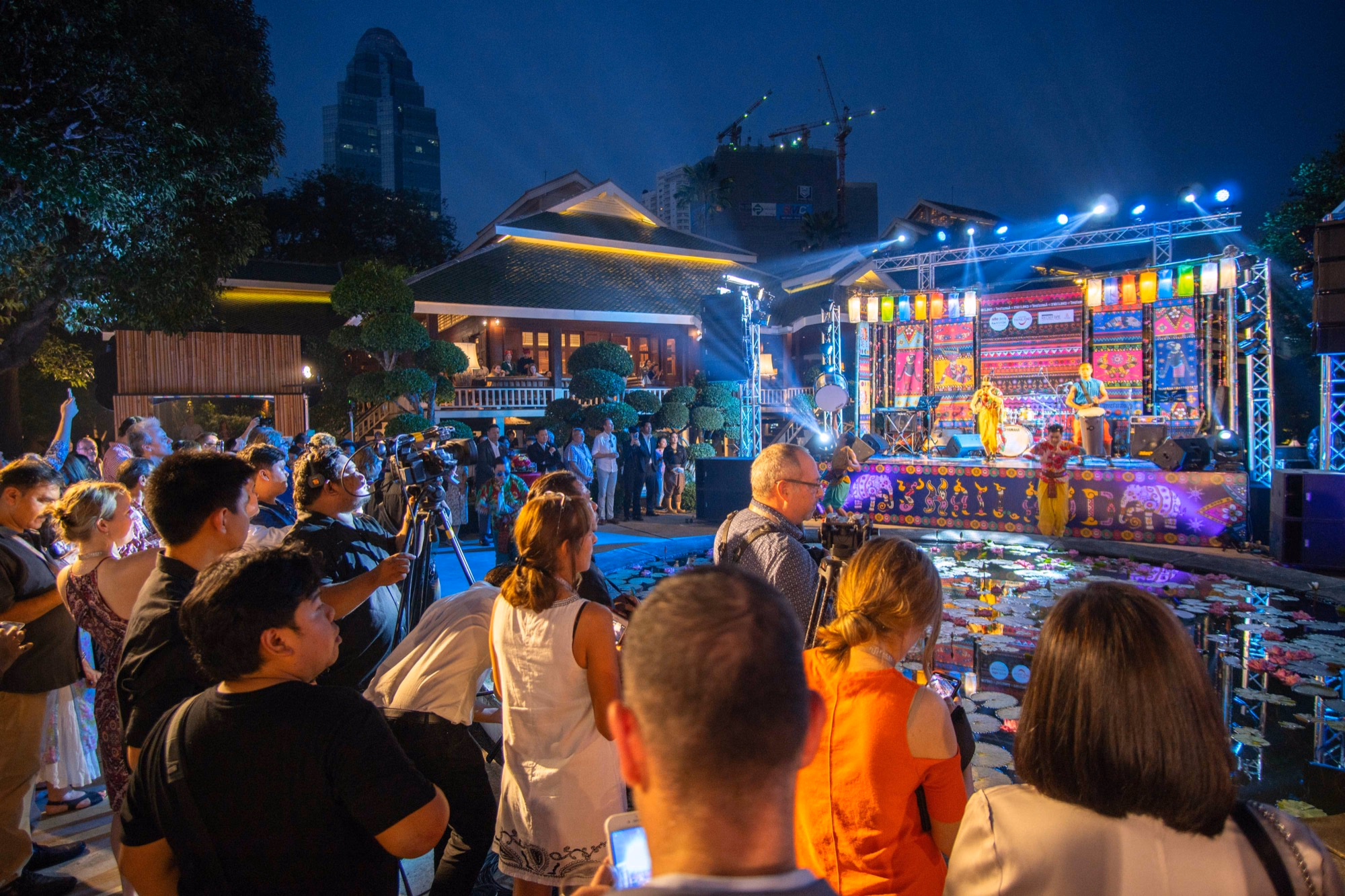 Guests watching a colourful live Thai performance at an evening event