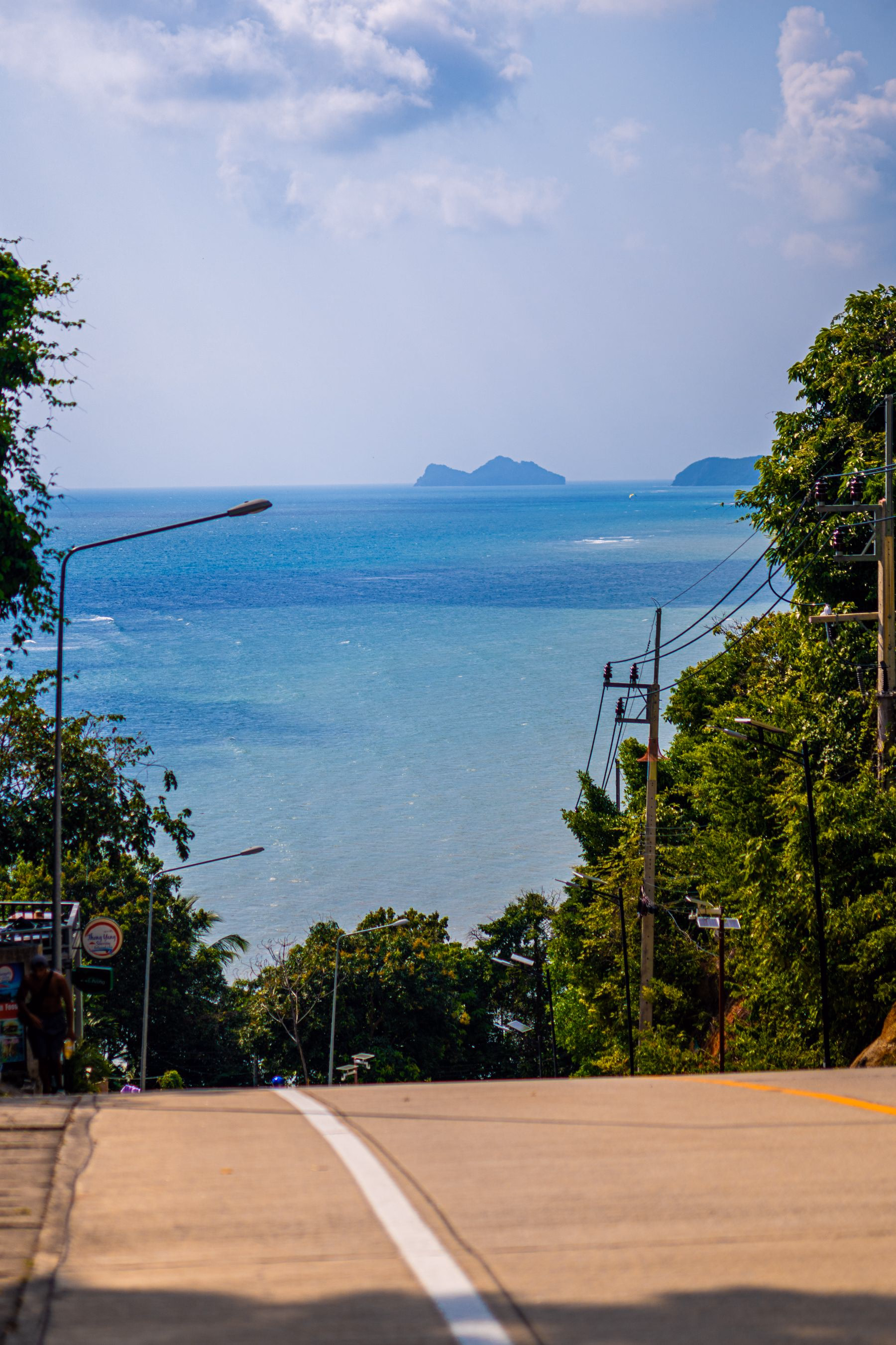 Blue sea and offshore islands viewed from a hillside road on Koh Samui