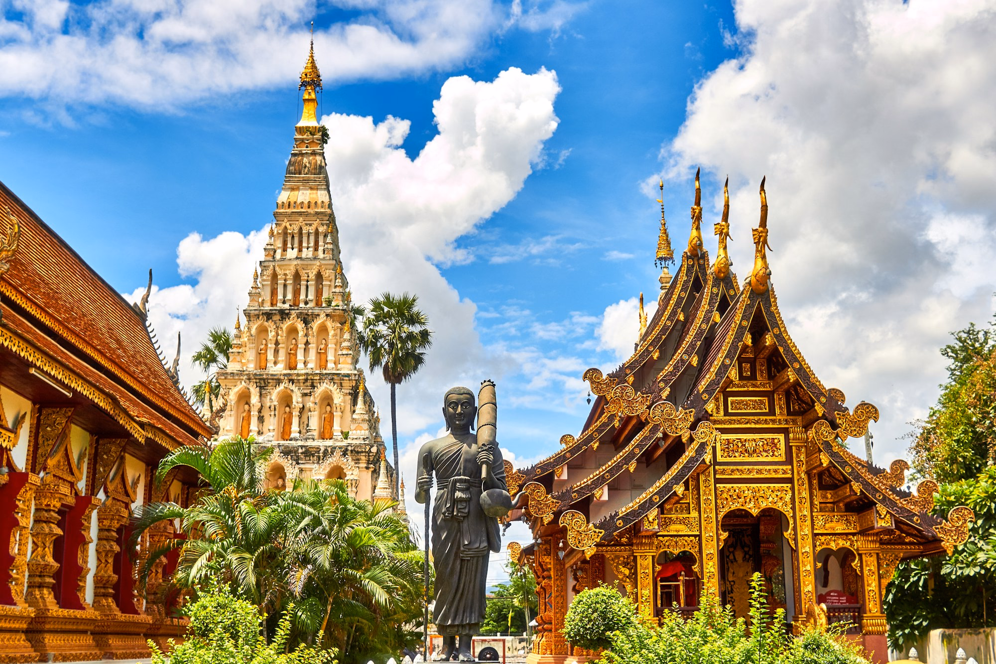 Detailed Thai temple architecture under a bright sky